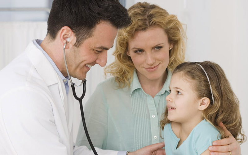 Doctor speaking with a little girl