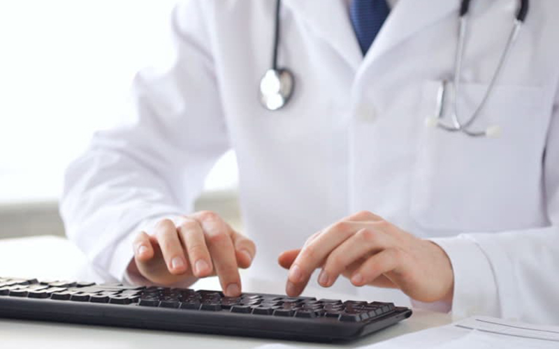 Doctor typing on a keyboard