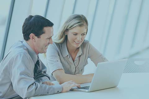 Two people working on a computer